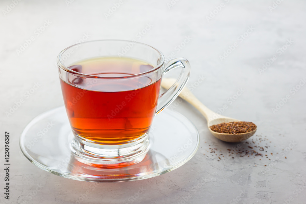 Healthy herbal rooibos red tea in glass cup, copy space Healthy herbal rooibos red tea in glass cup, copy space