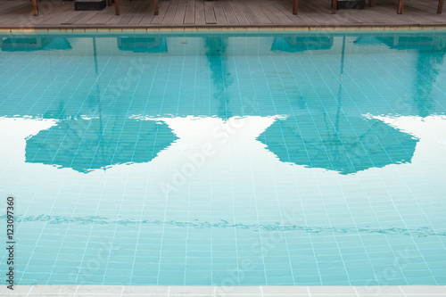 Swimming pool reflection shadow umbrella