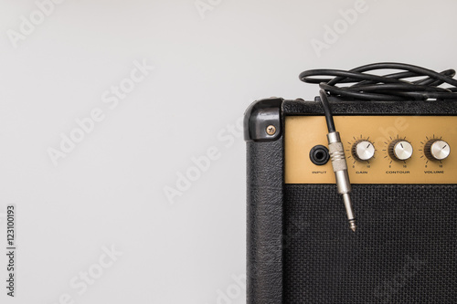 Принти на полотні Black guitar amplifier with jack cable on white background