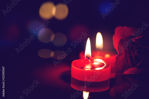 still life red candle light with reflection on dark stone ,abstract background for pray or meditation caption.
