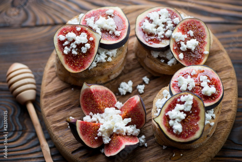 Bruschetta with fig fruits, honey and cottage cheese, closeup