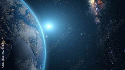 Fototapeta samoprzylepna Wschód słońca nad ziemią widziany z kosmosu. Z gwiazdami w tle.