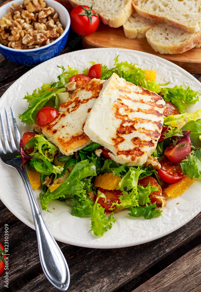 Grilled Halloumi Cheese salad witch orange, tomatoes and lettuce. healthy food
