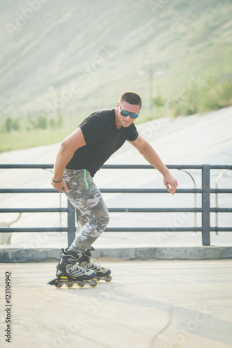 young man with inline skates ride in summer park seafront outdoor rollerskater © barbiturat