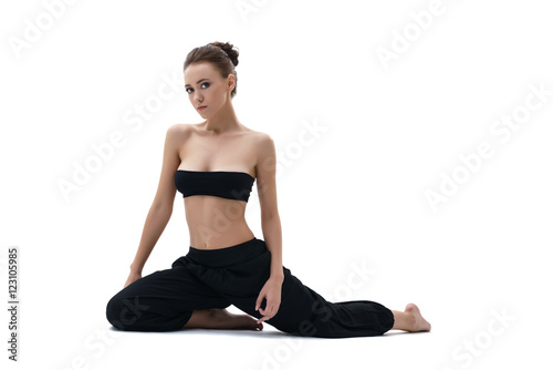 Yoga. Studio photo of beautiful girl sitting