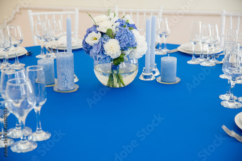 Festive table decoration in blue tones. Bouquet of blue hydrange photo
