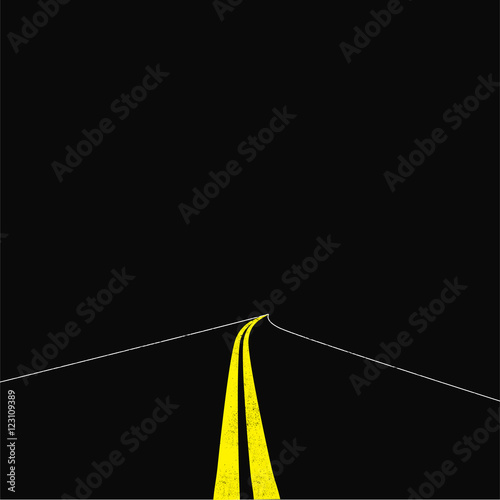 yellow dividing line on the road. dark background.