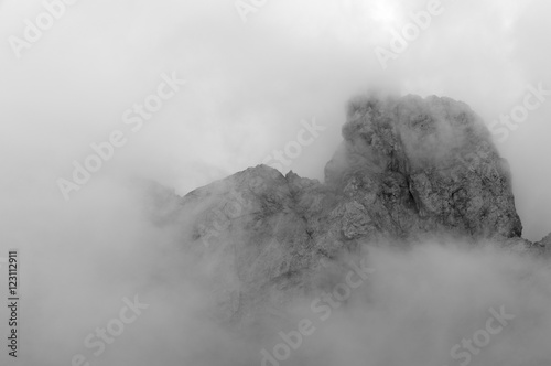 Mountain top on Marmolada glacier with clouds