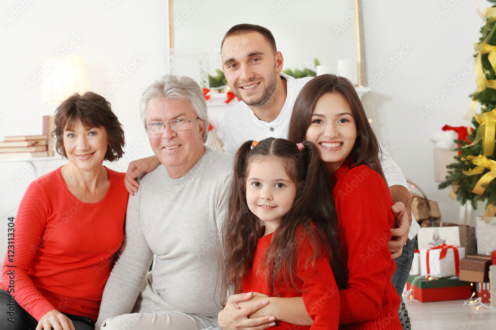 Happy family in living room decorated for Christmas Happy family in living room decorated for Christmas