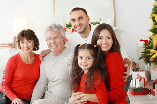 Happy family in living room decorated for Christmas