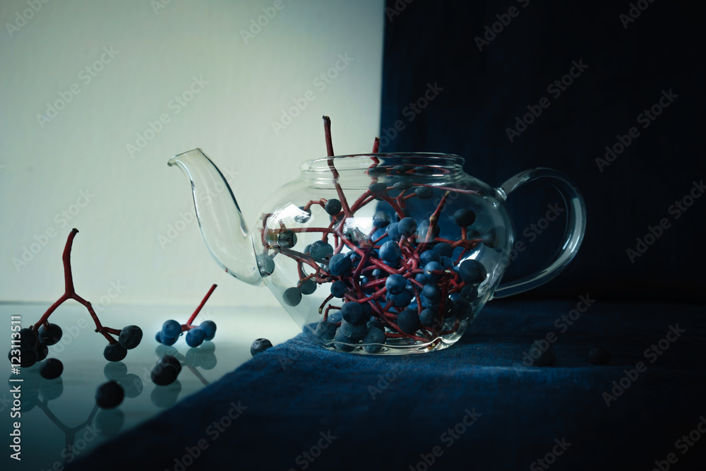 still life. bunches of wild grapes in a glass pot. close-up. still life. bunches of wild grapes in a glass pot. close-up.