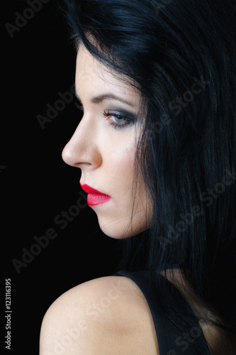 Portrait of the beautiful sad girl isolated on black background