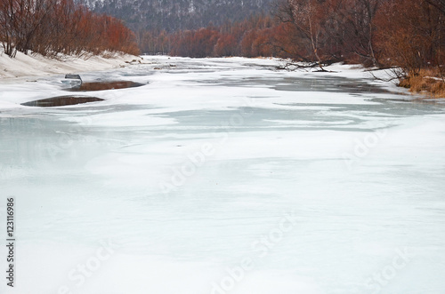 Fototapeta Naklejka Na Ścianę i Meble -  Icebound river on a cloudy spring day. Irkutsk Region