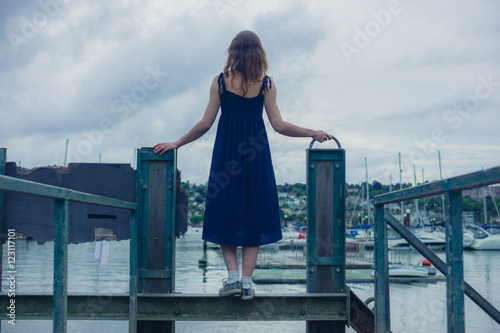 Young woman standing on steel bridge