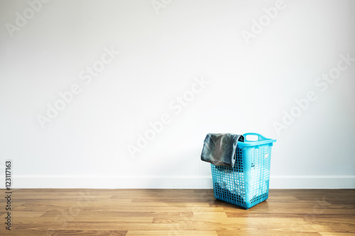 Laundry Basket on Wooden Floor and White Wall