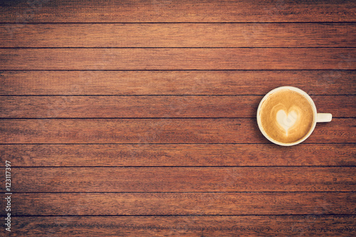 Latte coffee on table wood background with space