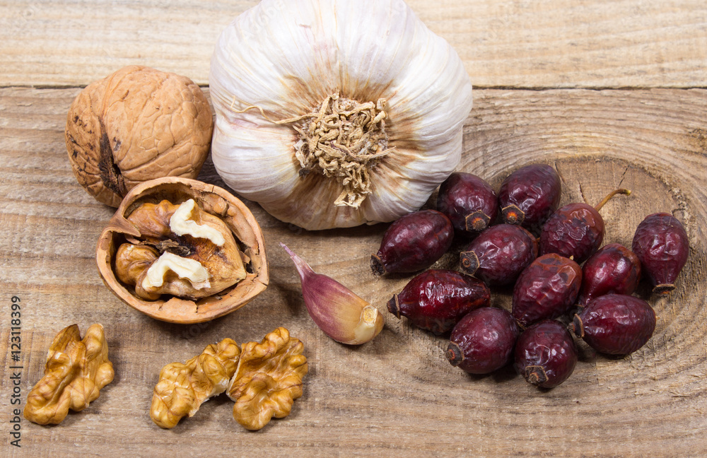 Dried fruit of hawthorn, garlic and walnuts. The concept of alternative medicine. Dried fruit of hawthorn, garlic and walnuts. The concept of alternative medicine.