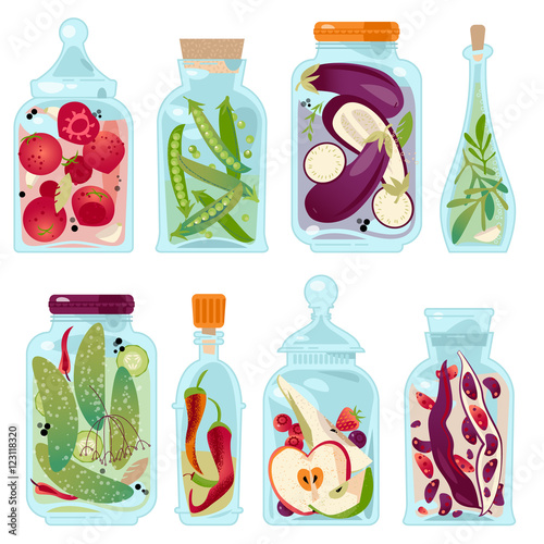 Different glass jars with preserved vegetables and fruit.