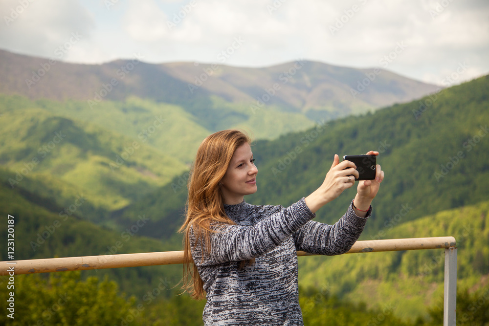 Young woman taking photos of nature 