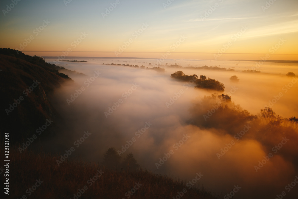 Misty sunrise on the river and on the forest Misty sunrise on the river and on the forest