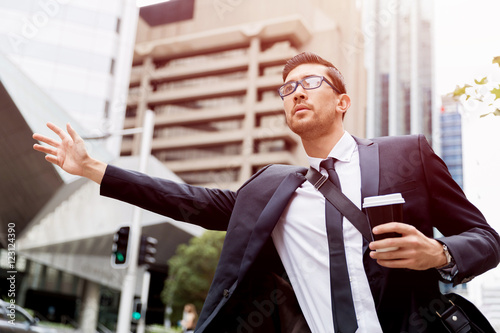 Young businessmen hailing for a taxi