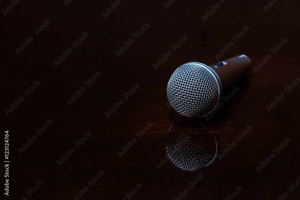 Obraz premium Vocal microphone on dark polished surface