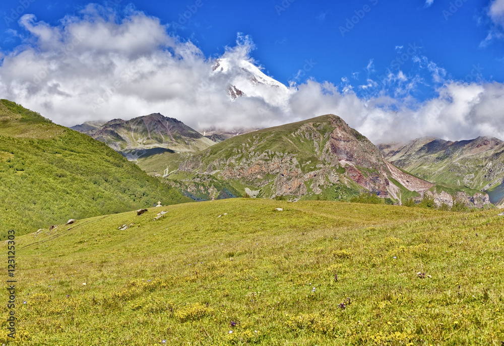 Beautiful mountain landscape and green hills, bright blue sky. N