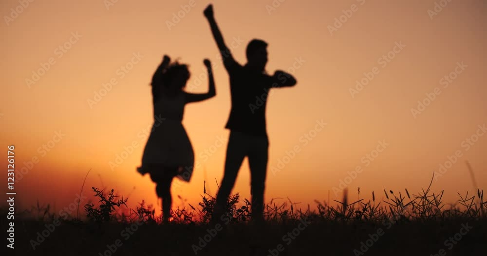 young happy couple having fun dancing on the sunset young happy couple having fun dancing on the sunset