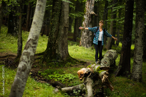 woman walking in balance on a stump photo