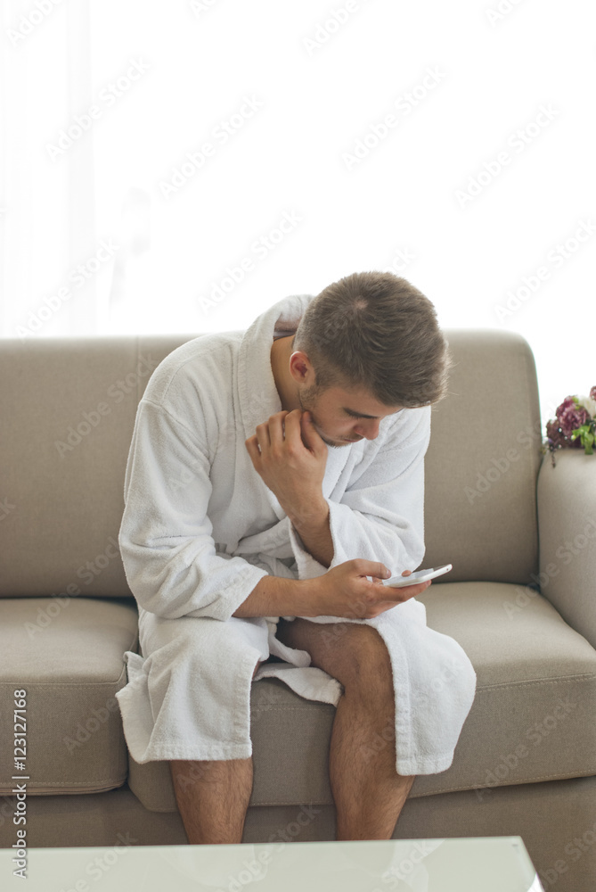 Handsome man relaxing in bathrobe 