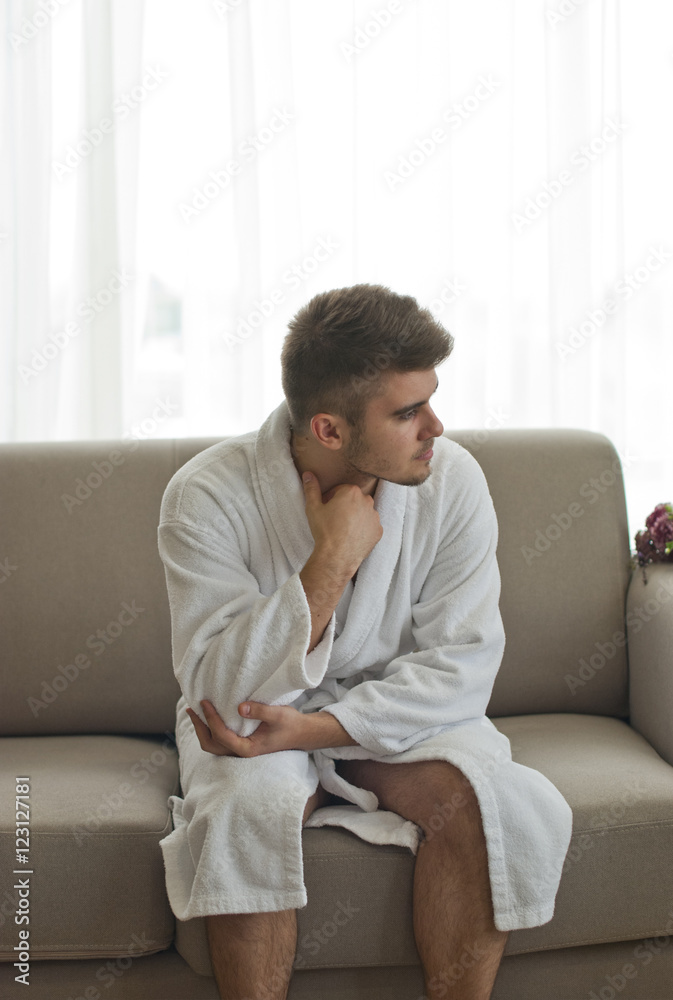 Handsome man relaxing in bathrobe 