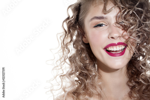pretty smiling girl with curly hair and shadow on the beauty face