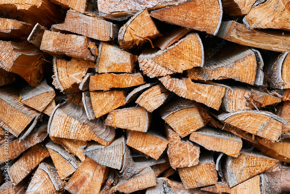 Chopped firewoods for the fireplace stacked for winter Chopped firewoods for the fireplace stacked for winter
