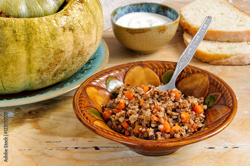 Tasty autumn stuffed pumpkin with buckweat and mushrooms photo