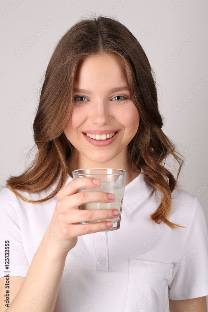 Model holding glass of milk. Close up.White background Model holding glass of milk. Close up.White background