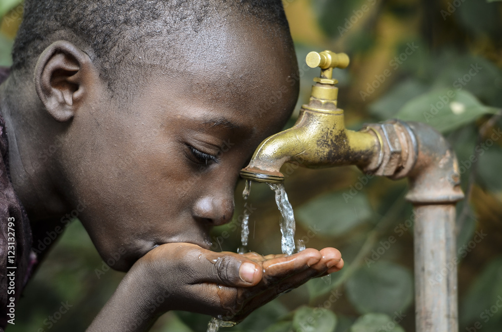 Little African Boy Drinking Healthy Clean Water from Tap Stock Photo