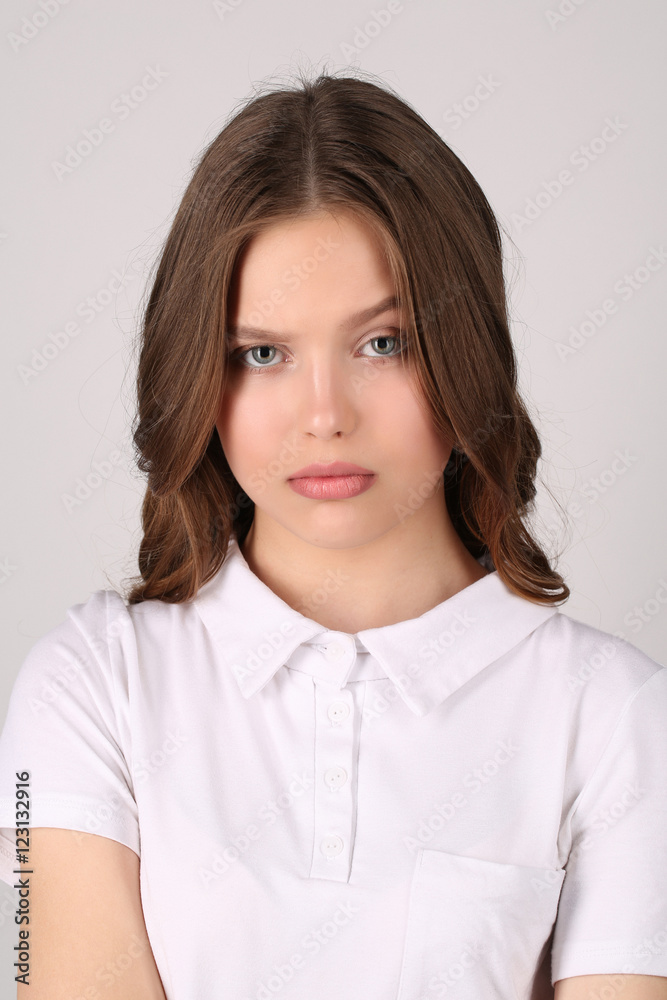 Model with grimace in T-shirt. Close up. White background Model with grimace in T-shirt. Close up. White background