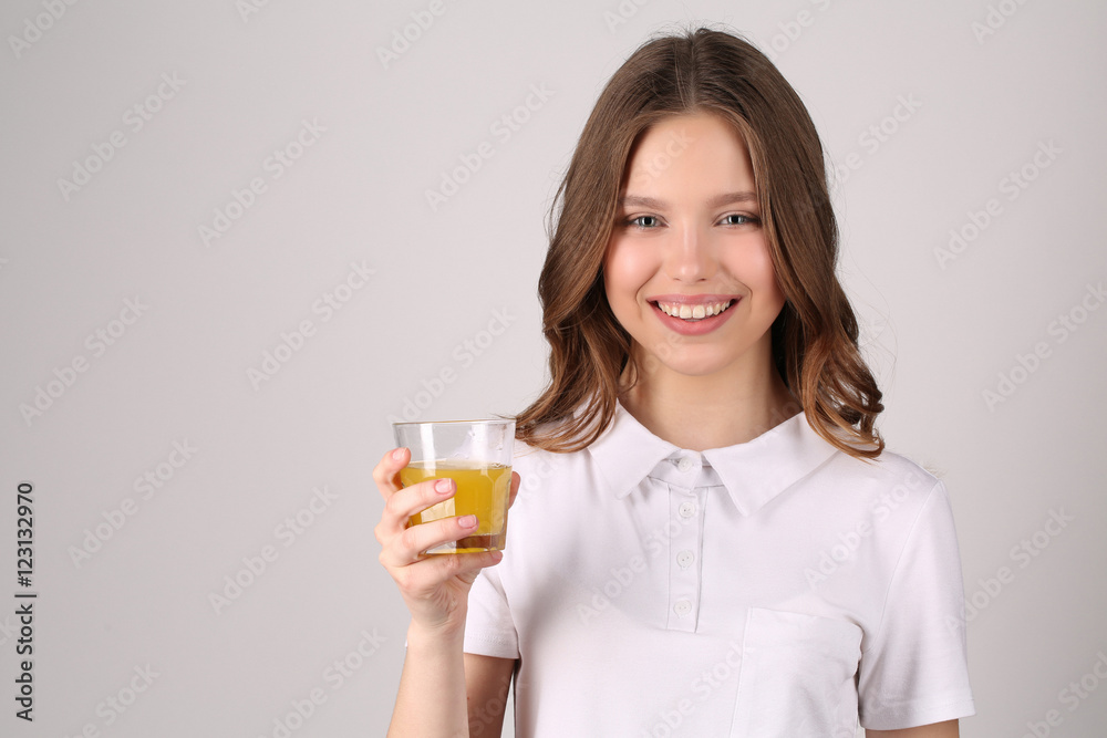 Girl posing with glass of juice. Close up. White background Girl posing with glass of juice. Close up. White background