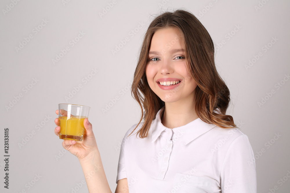 Girl with glass of juice. Close up. White background Girl with glass of juice. Close up. White background