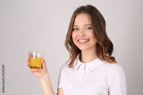 Girl with glass of juice. Close up. White background