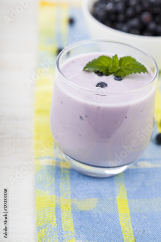 Smoothie with blueberries on a wooden table