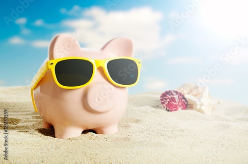 Piggy bank on vacation. Concept of holidays economy