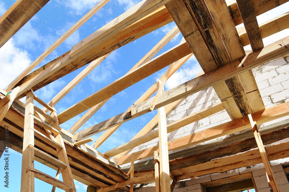 New residential construction home framing against a blue sky. Roofing construction. installation of insulation wool. white building blocks. unfinished plaster.