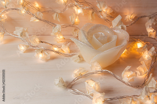 Fényképezés Burning lights and candle rose on white wooden background