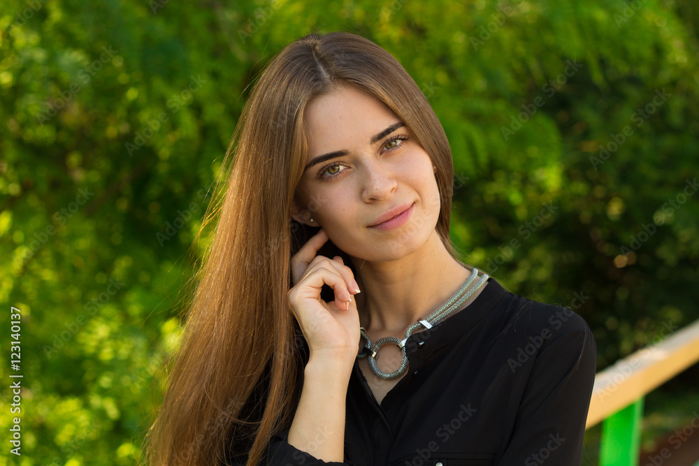 Young woman on the background of trees Young woman on the background of trees