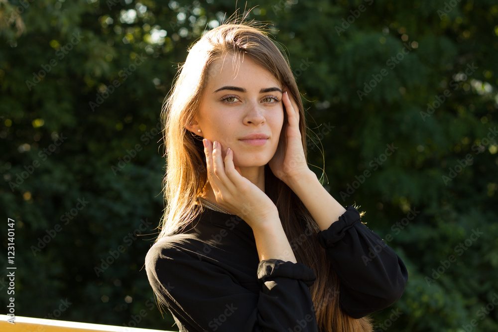 Young woman on the background of trees Young woman on the background of trees