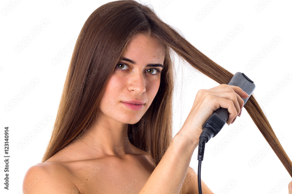 Woman using hair straightener Woman using hair straightener