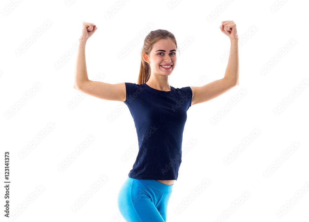 Smiling woman showing biceps Smiling woman showing biceps