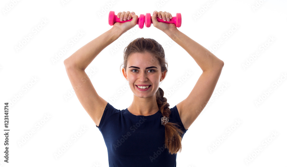 Smiling woman holding two dumbbells over her head