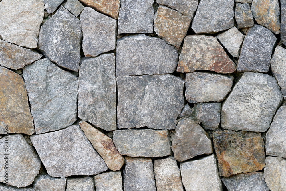 old stone wall Texture in weathered and have natural surfaces. old stone wall Texture in weathered and have natural surfaces.